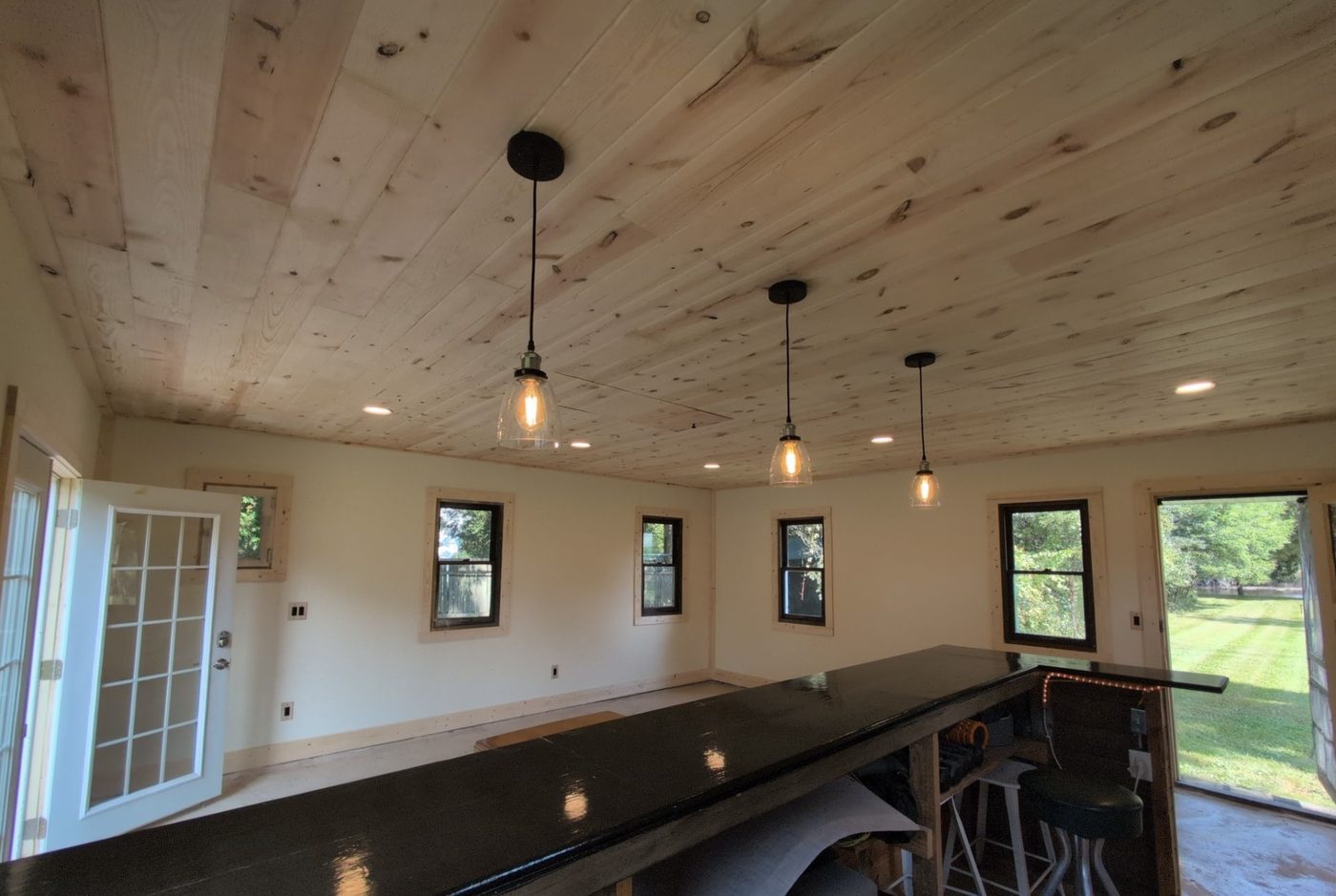 Remodeled room with pendant and recessed lighting